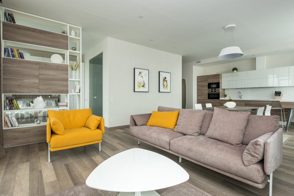 Spacious and elegant modern living room with cozy yellow accents and contemporary decor.